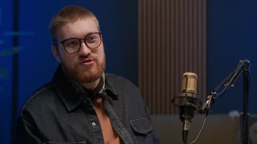 Young Male Radio Presenter Speaking in Mic in Recording Studio
