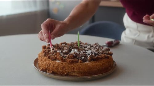 Adding Candles to Birthday Cake Celebration Preparation
