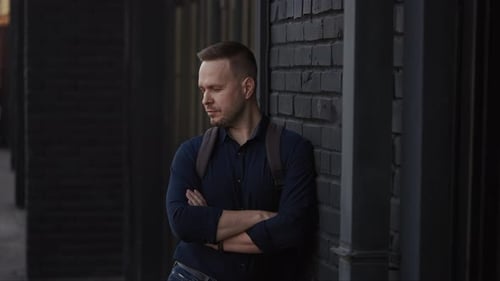 City Street Portrait of a Man in a Shirt and with a Backpack Modern Lifestyle in the City