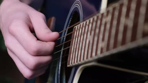 Guitar Close-Up: Hands Playing Acoustic Instrument