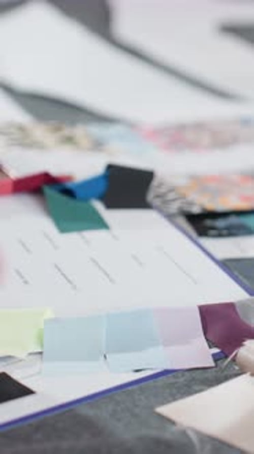 Hand Selecting Fabric Samples at Creative Workplace
