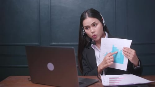 Business Woman Explaining Charts Over Laptop