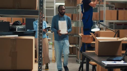 People Loading and Scanning Boxes in Warehouse