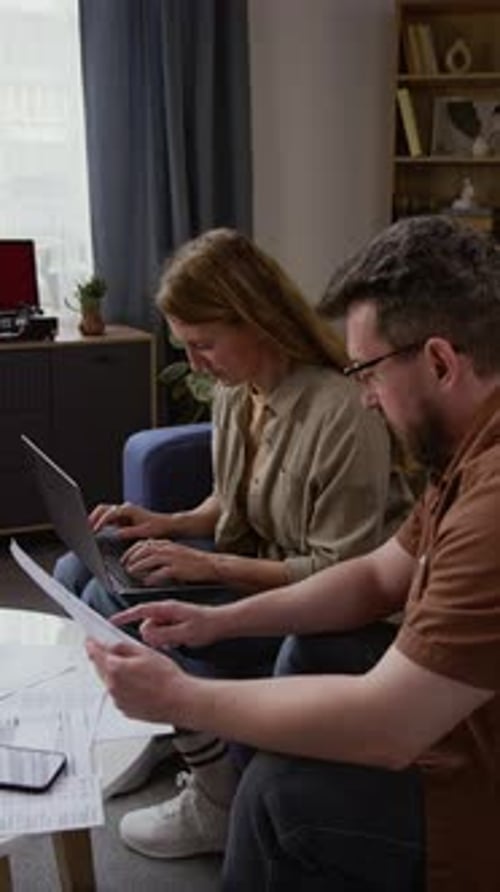 Couple Reviews Finances Together in Living Room