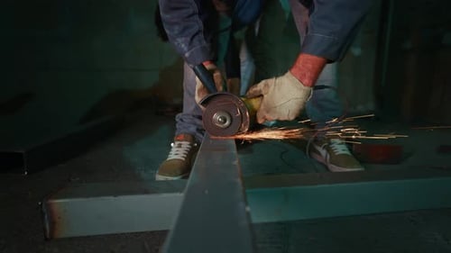 Grinding and Polishing Steel Beams Carefully Operator Smoothing Metal Edge with Sparks Flying Around