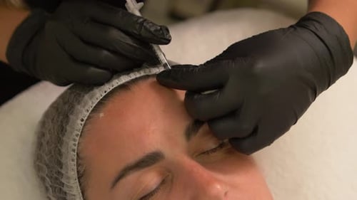 Beauty Clinic Beautician Hands in Gloves Making Face Aging Injection in a Female Skin A Woman Gets