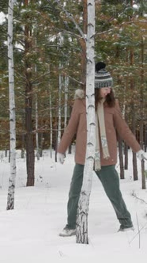 Vertical of Happy Family with Sled and Thermos Going for Winter Forest Hike