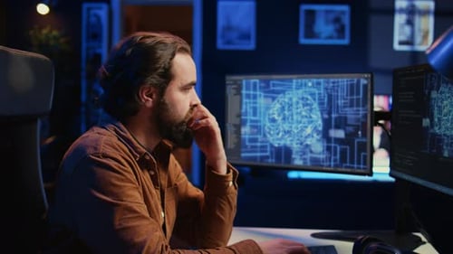 Man Coding Brain Data on Computer at Night