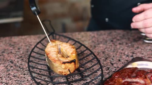 chef prepares a salmon dish in the kitchen. Close-up shots