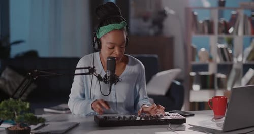 Woman Playing Keyboard and Singing into Microphone
