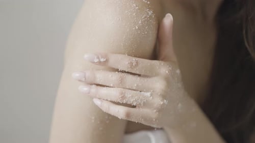Woman Applies Sugar Scrub to Arm and Shoulder