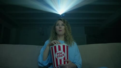 Woman Watches Movie with Popcorn at Home