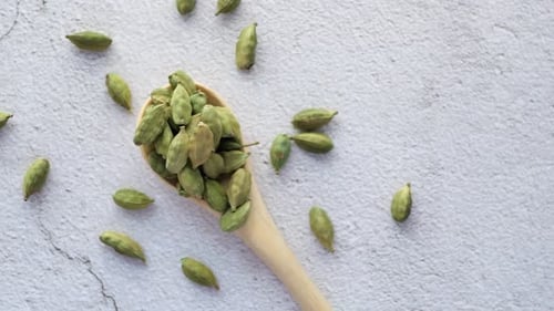 Close Up of Cardamom on a Spoon on Table