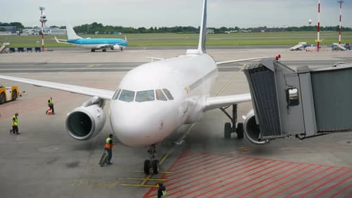 Passenger airliner parked at terminal gate during airport ground handling