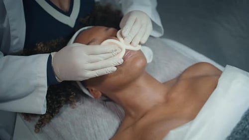 Hands Cleaning Face Pads in Beauty Salon Closeup Beautician Wiping Smooth Skin