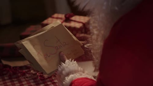 Santa Claus Reading Letters in Cozy Setting