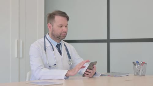 Medical Professional Using Smartphone in Bright Office