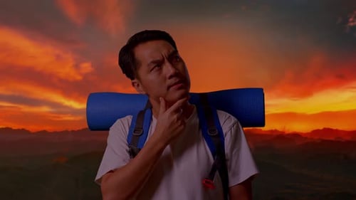 Close Up Of Asian Male Thinking About Something And Looking Around On Top Mountain