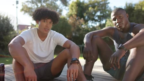 Athletic Men Resting and Smiling After Workout