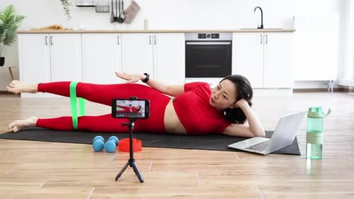 Woman Exercises At Home With Resistance Band