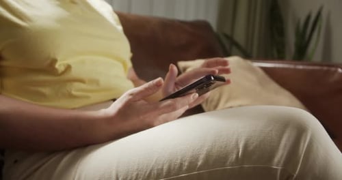 Woman Using App on Mobile Phone at Home