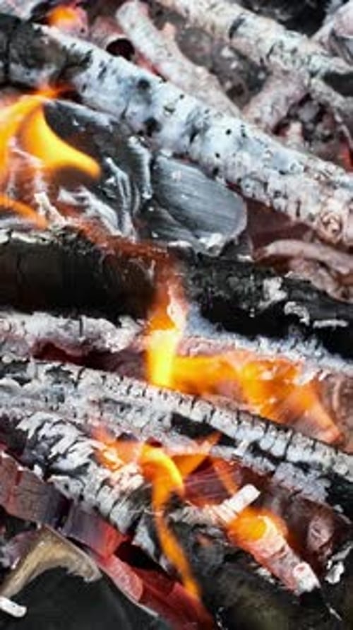 Burning Flames on Wood Creating Fiery Patterns