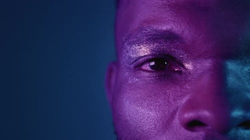 Close Up Portrait of a Beautiful African American Man in the Studio Attractive Guy Opens Eyes Neon