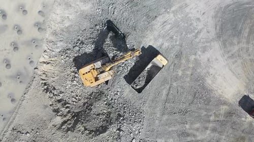Excavator Working Hard at a Quarry from Above