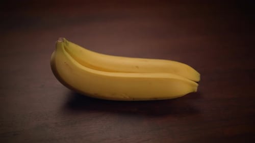 Close Up of Yellow Bananas on Wood Surface