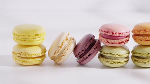 An Array of Colorful Macarons is Arranged in a Row on a White Background