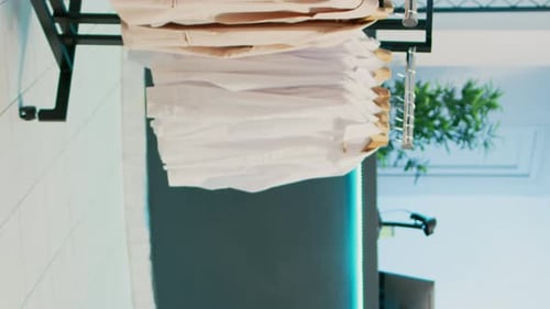 Vertical Video Empty Clothing Store Filled with Racks and Hangers
