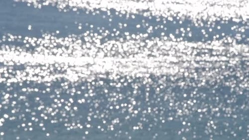 Abstract Sparkling Sunlight Reflecting on Blue Water