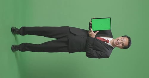 Full Body Of Asian Business Man Showing Tablet Green Screen On Green Screen Background In The Studio