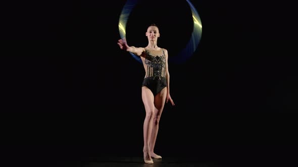 Skillful Pretty Rhythmic Gymnast Performing Variety of Hoop Rotation ...