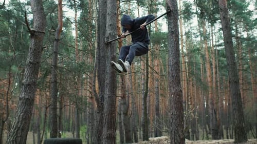 Outdoor Workout Young Fit Man Trains in the Forest Calisthenics Outdoor Training Man Doing Pull Ups