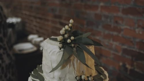 Dolly close up of beautiful decorated wedding cake ready for celebration