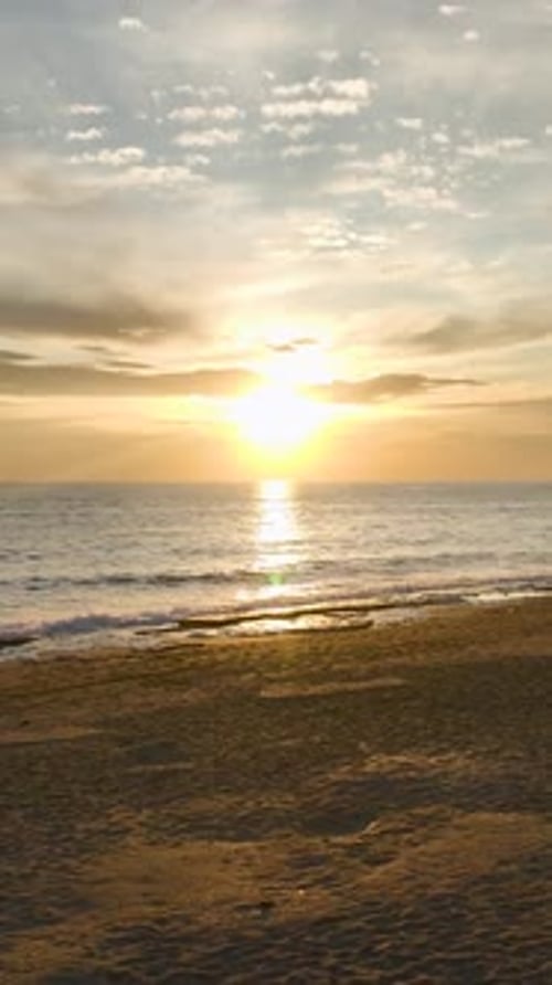 Vertical Video Aerial Sunset Glow Views Above the Sea
