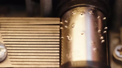Detailed view of the interior of an old music box during play. Gears of the music box rotate.