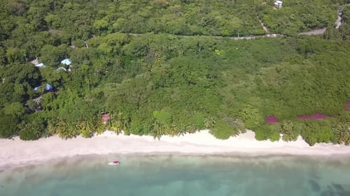 Aerial ascending angle over tropical beach and forest