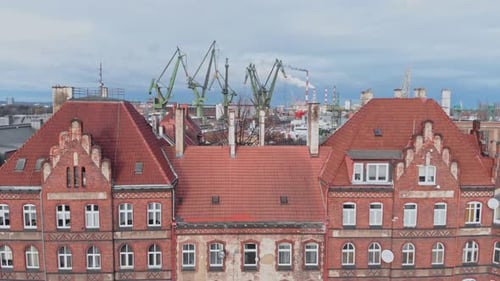 Aerial View of a Large Building with Many Windows and a Crane in the Background