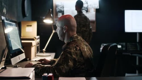 Cybersecurity Agents Detecting Hacker Attack on Computer in Military Office