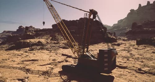 Heavy Machinery Works on Rocky Terrain During Golden Hour