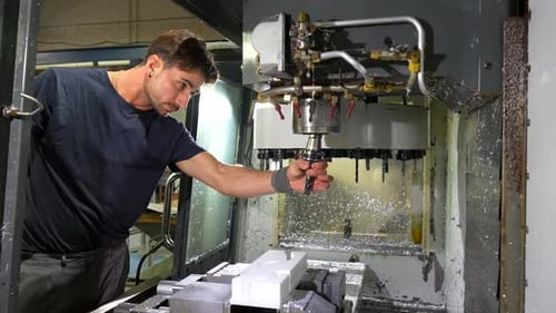Man Working in the Machining Center for Plastic Parts