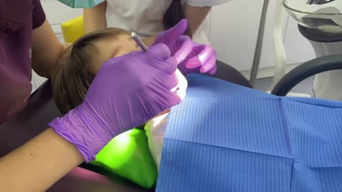 Child Receiving Dental Exam at Dentist Office