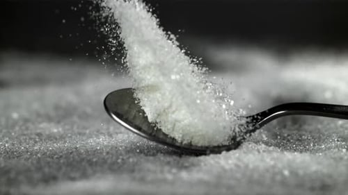 A Spoonful of Sugar Falls on the Table Filmed on a Highspeed Camera at 1000 Fps