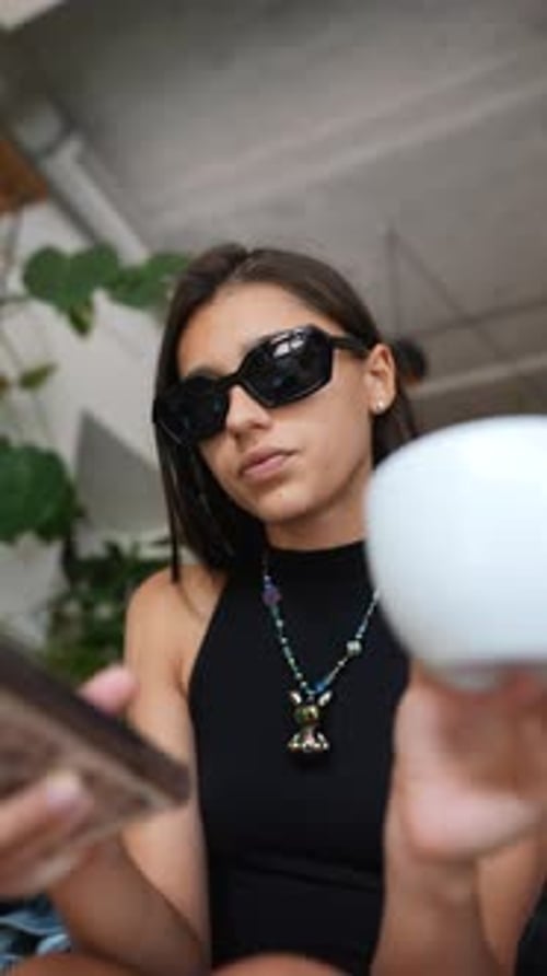 Stylish Woman with Phone and Coffee in Urban Setting