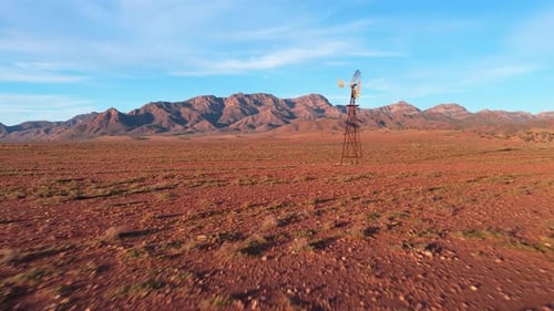 Low Drone Flight Toward Windmill on Red Outback Plains, Flinders Ranges