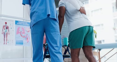 Health Professional Helping Patient with a Walker