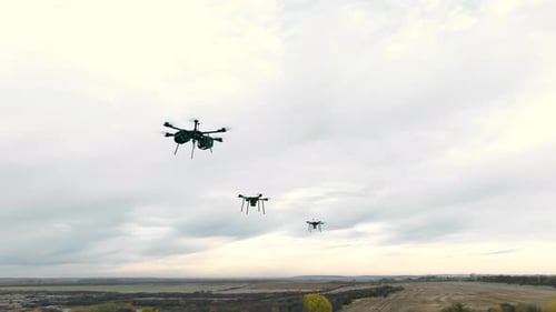 Combat Military Drones Fly on the Sky Background