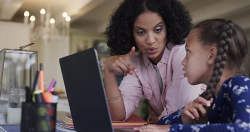 Woman Teaching Child at Home on Laptop